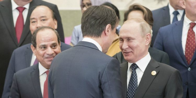 Il premier Giuseppe Conte (di spalle) a Pechino tra al Sisi e Putin (LaPresse)