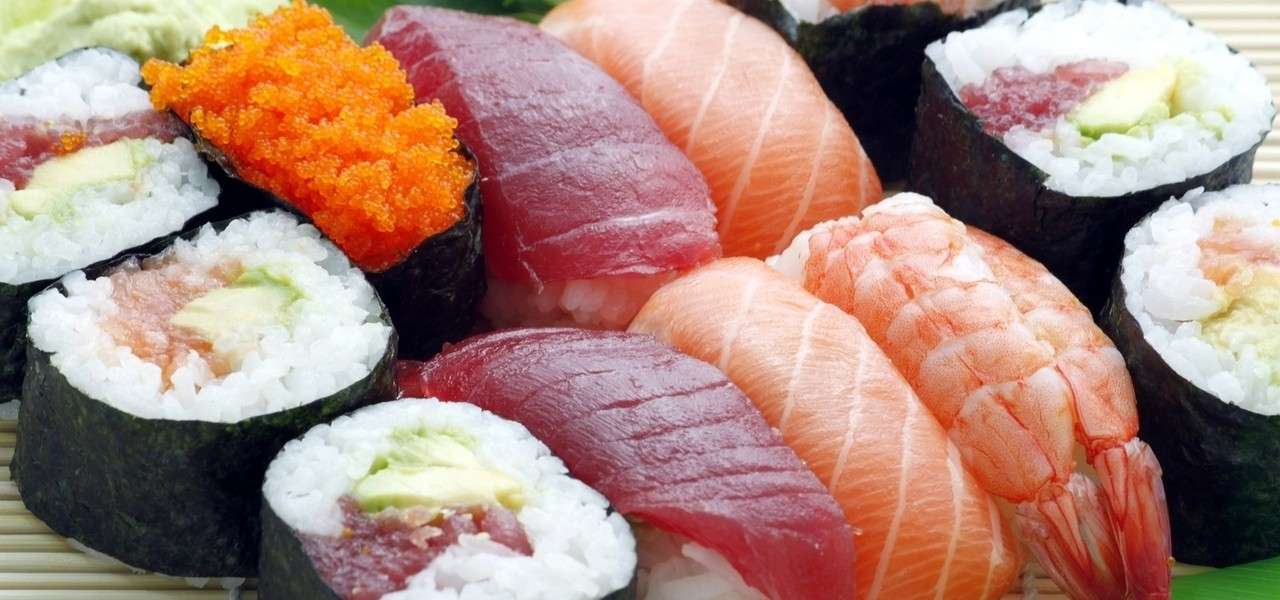 Bugia del rotolo di sushi su una priorità bassa della stuoia di