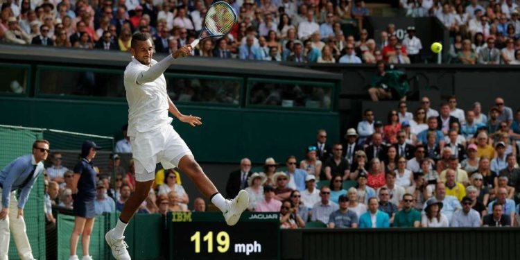 Australia's Nick Kyrgios returns against Spain's Rafael Nadal during their men's singles second round match on the fourth day of the 2019 Wimbledon Championships at The All England Lawn Tennis Club in Wimbledon, southwest London, on July 4, 2019. (Photo by Adrian DENNIS / AFP) / RESTRICTED TO EDITORIAL USE