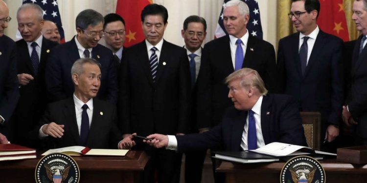 President Donald Trump signs a trade agreement with Chinese Vice Premier Liu He, in the East Room of the White House, Wednesday, Jan. 15, 2020, in Washington. (AP Photo/Evan Vucci)