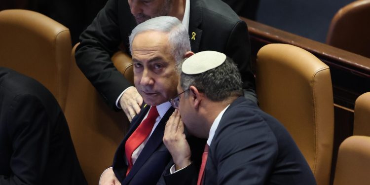 Benjamin Netanyahu, premier di Israele, alla Knesset mentre parla con Itamar Ben-Gvir (Ansa)